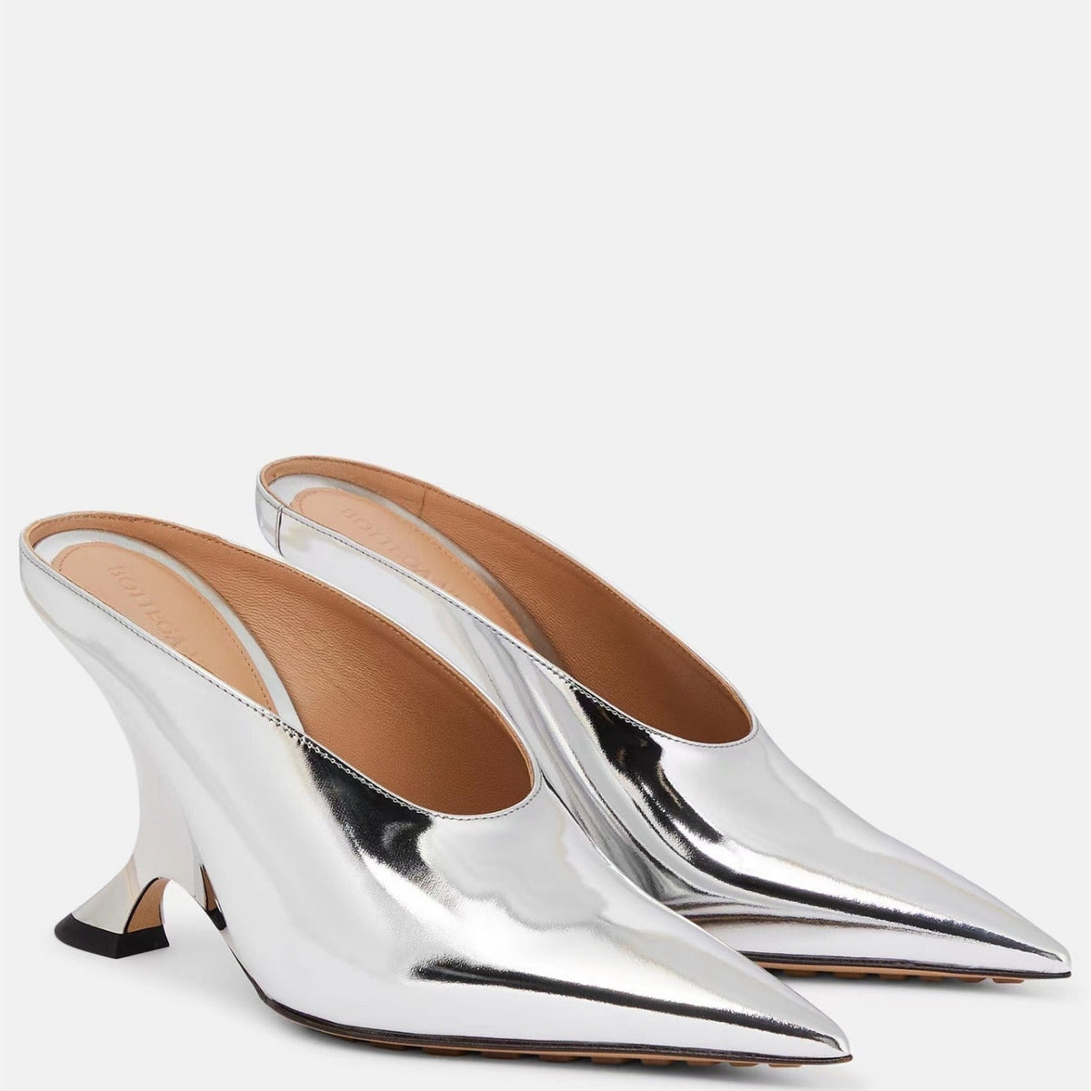 Shimmering metallic pointed toe mules for women, designed with a trendy wedge and unique sculpted statement heel.