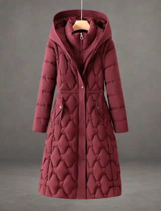 Warm hooded maxi puffer jacket for women, featuring elegant quilting and long design.