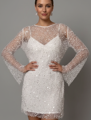 Woman wearing embellished mesh mini dress front view on gray background.