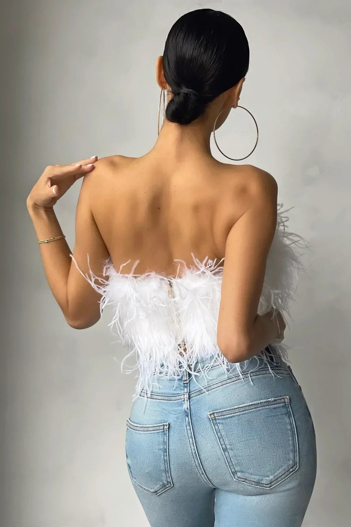 Women's elegant tube top with luxurious feather trim, ideal for going out.