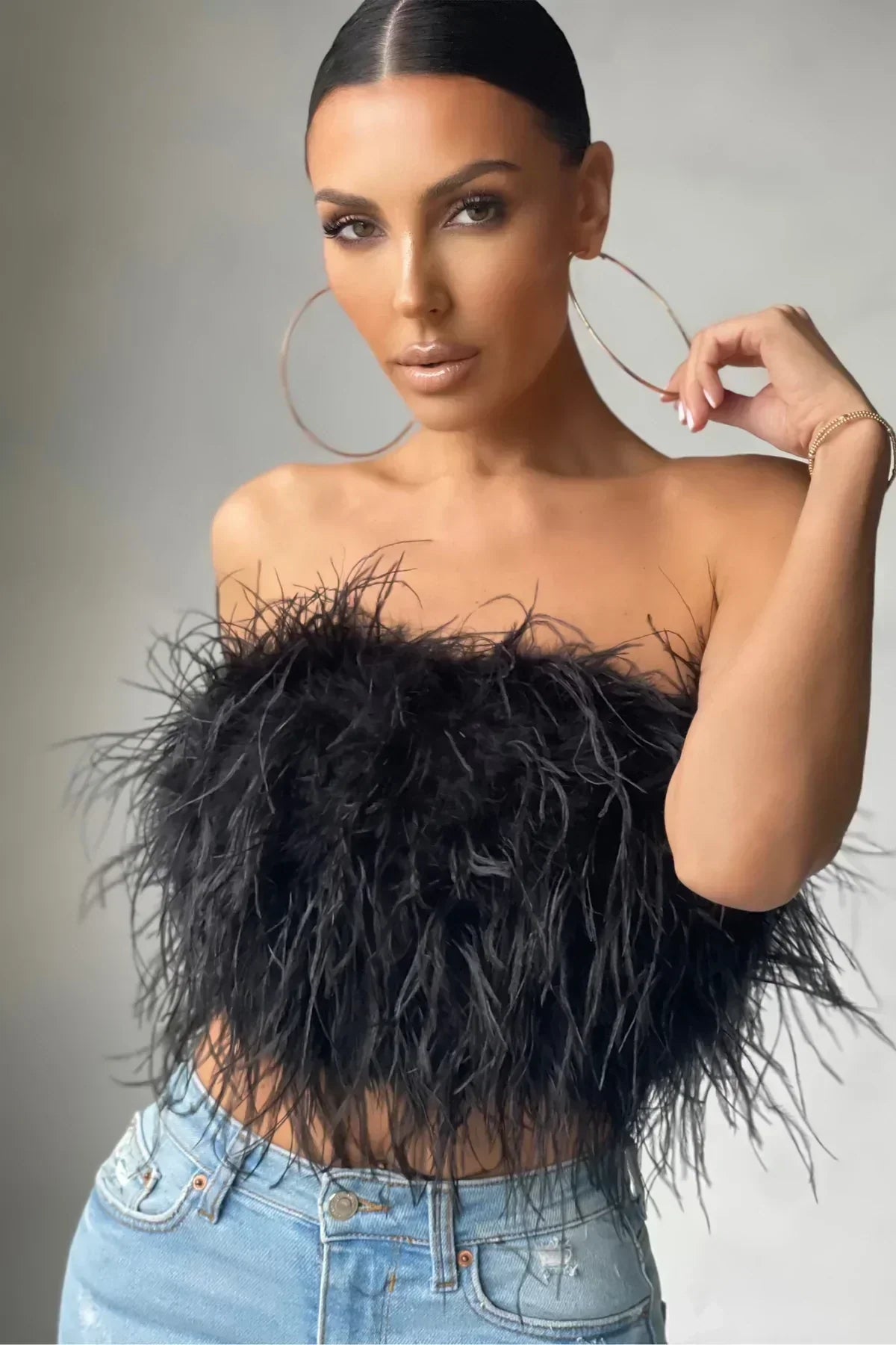Stylish feather-detail crop top, a fashionable women's party wear essential.