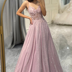 Flowing light pink women's maxi dress with elegant embellishments, ideal for formal parties or wedding guests.