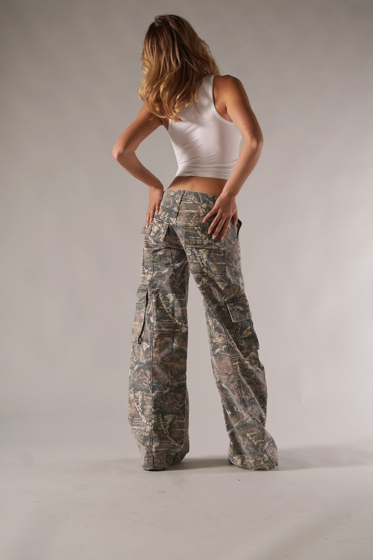 Unisex camo cargo pants with rugged utility pockets, featuring a relaxed fit and bold camo print for urban or outdoor style.